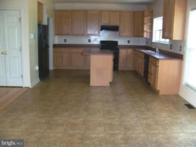 4 Gallery Road Stafford, VA 22554 - Photo 5 of 21 a kitchen with stainless steel appliances granite countertop a stove a sink and a refrigerator