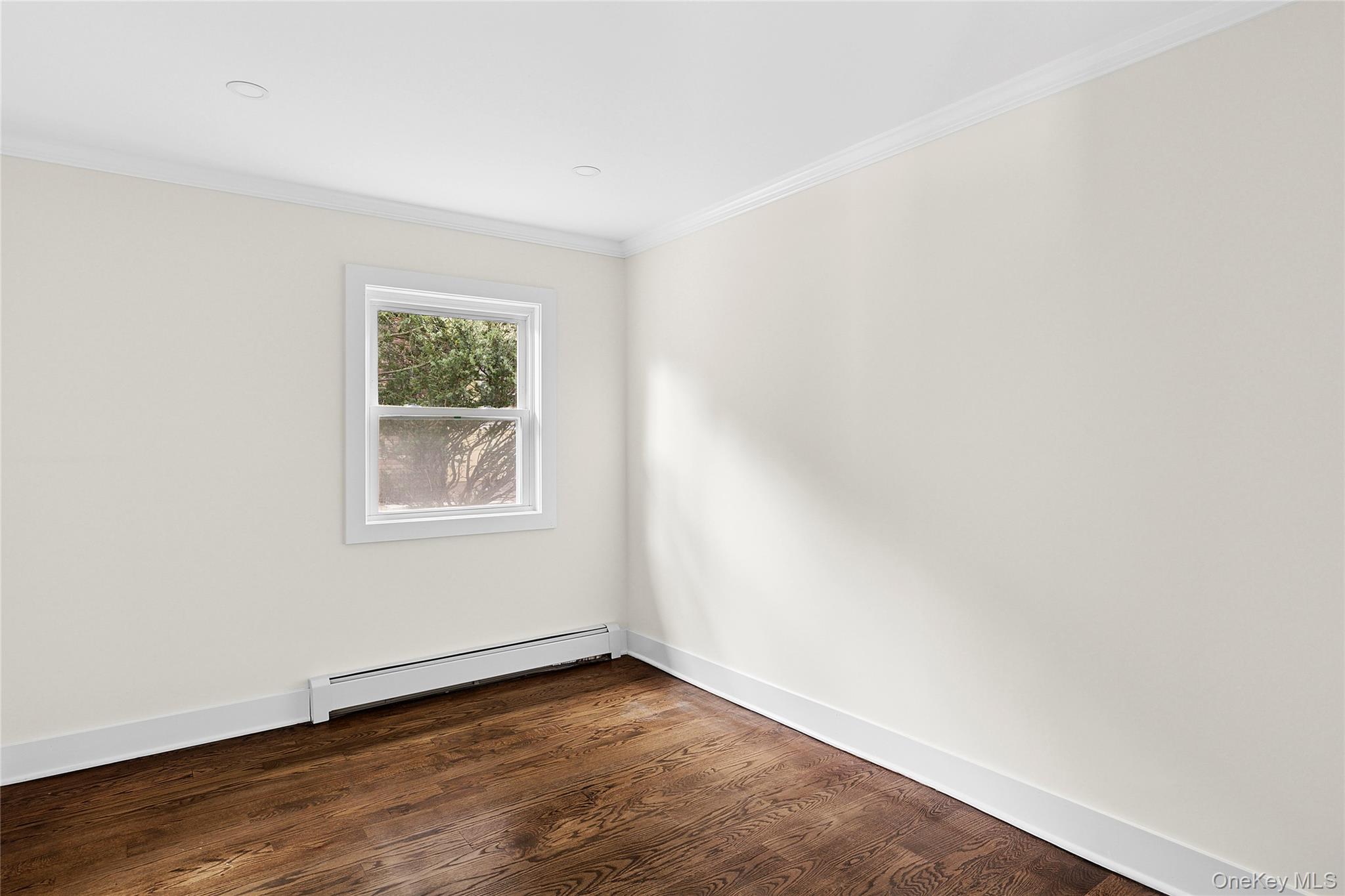 21 A Neulist Avenue Port Washington, NY 11050 - Photo 12 of 17 an empty room with wooden floor and windows