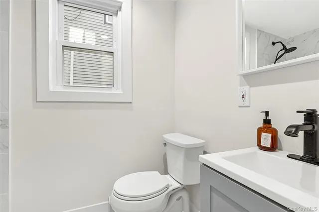 a white toilet sitting next to a bathroom sink
