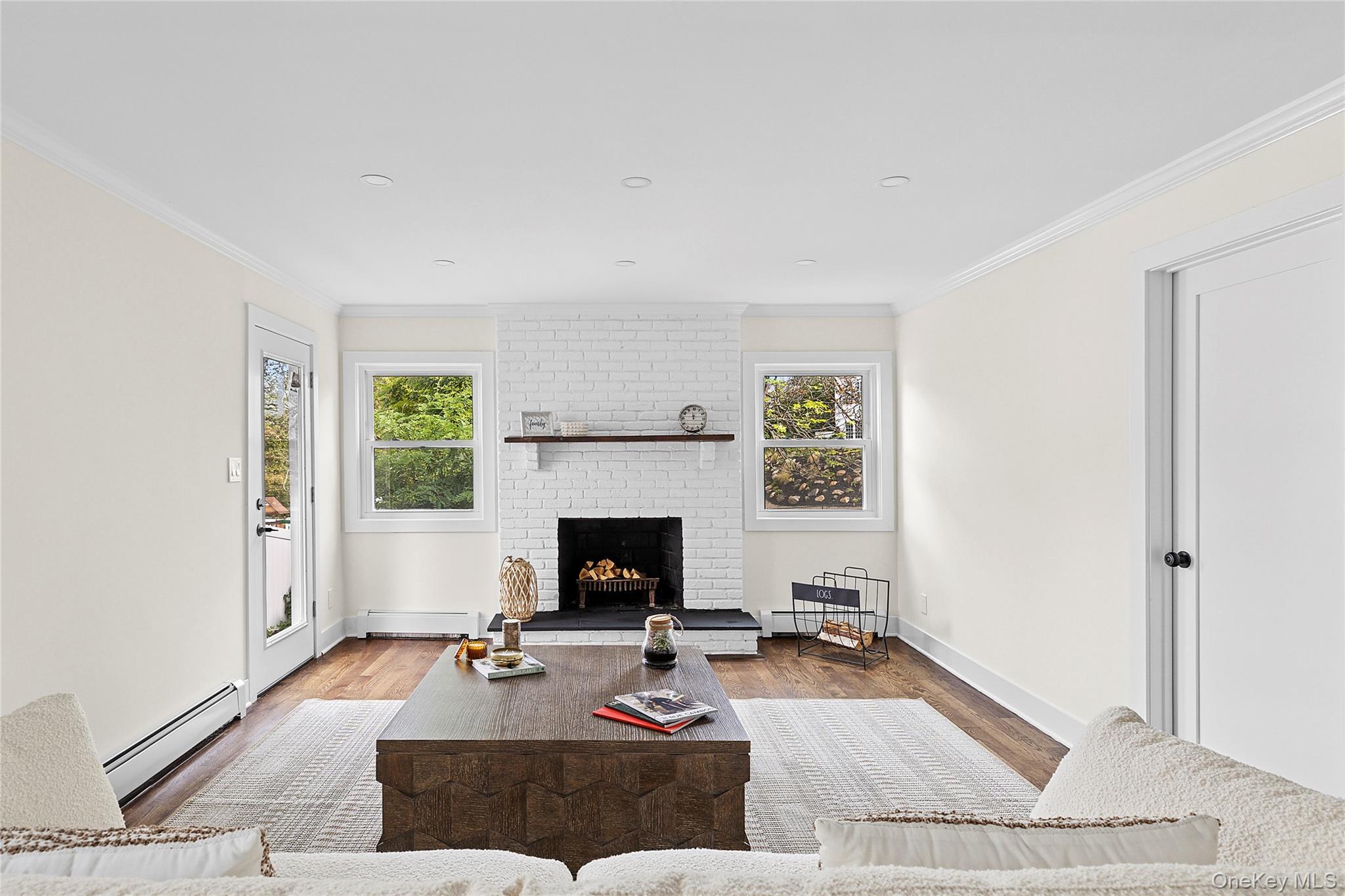 21 A Neulist Avenue Port Washington, NY 11050 - Photo 8 of 17 a living room with furniture and a fireplace