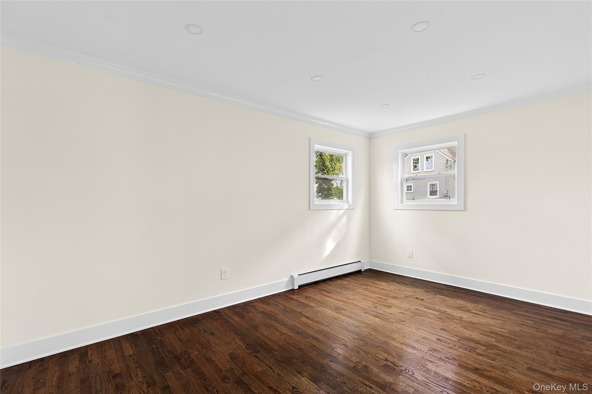 21 A Neulist Avenue Port Washington, NY 11050 - Photo 10 of 17 an empty room with wooden floor and windows
