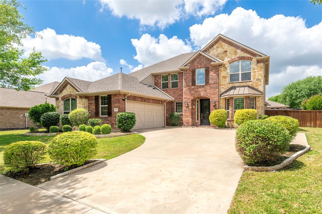 12571 Valley Spring Drive Frisco, TX 75035 - Photo 2 of 39 a front view of a house with a yard