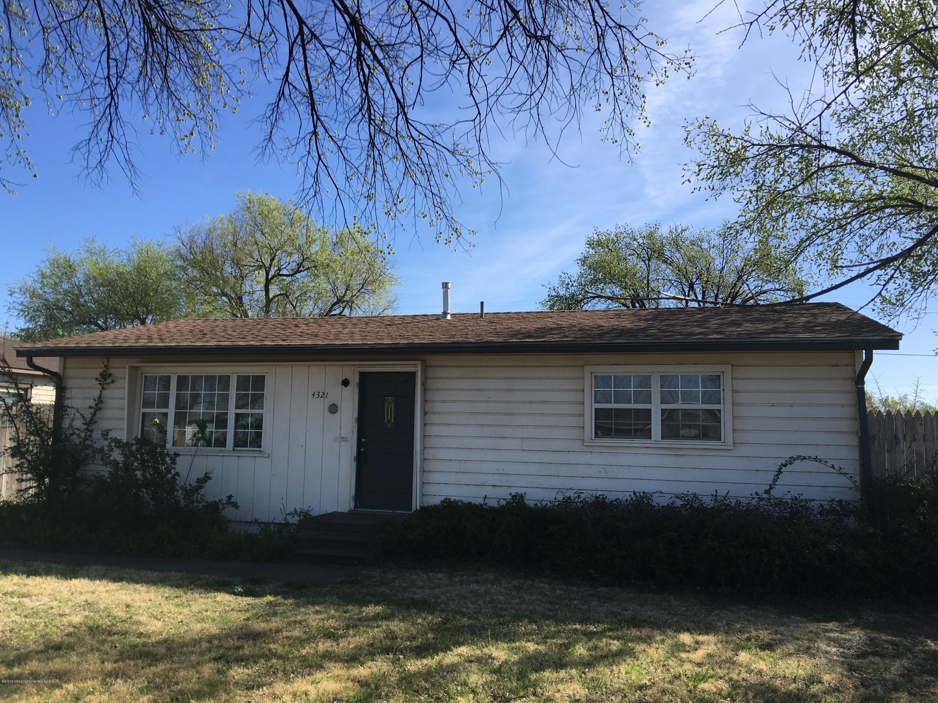 4321 South Travis Street Amarillo, TX 79110 - Photo 1 of 38 a backyard of a house with lots of green space