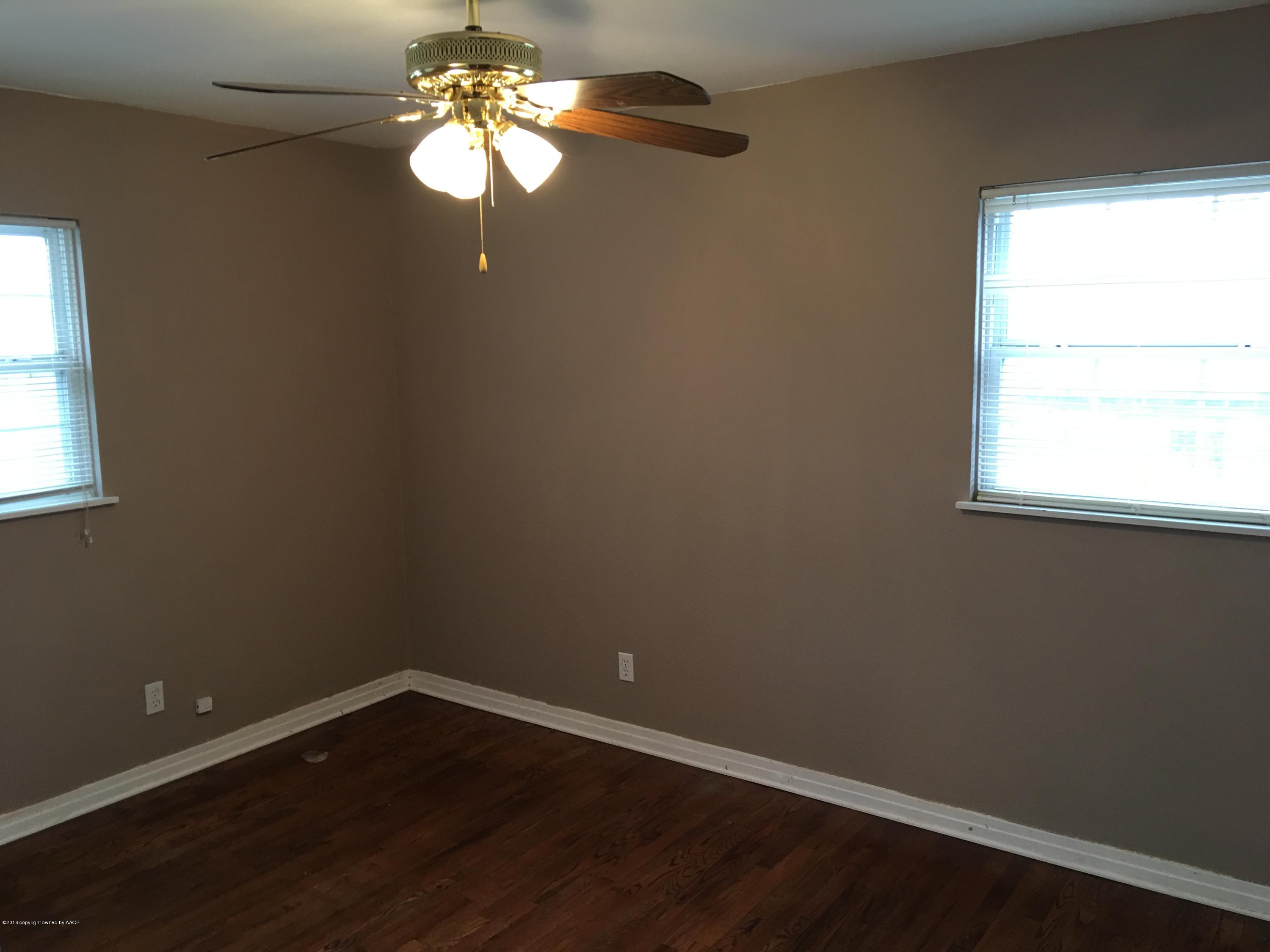 4321 South Travis Street Amarillo, TX 79110 - Photo 13 of 38 a view of a small space with wooden floor and a window