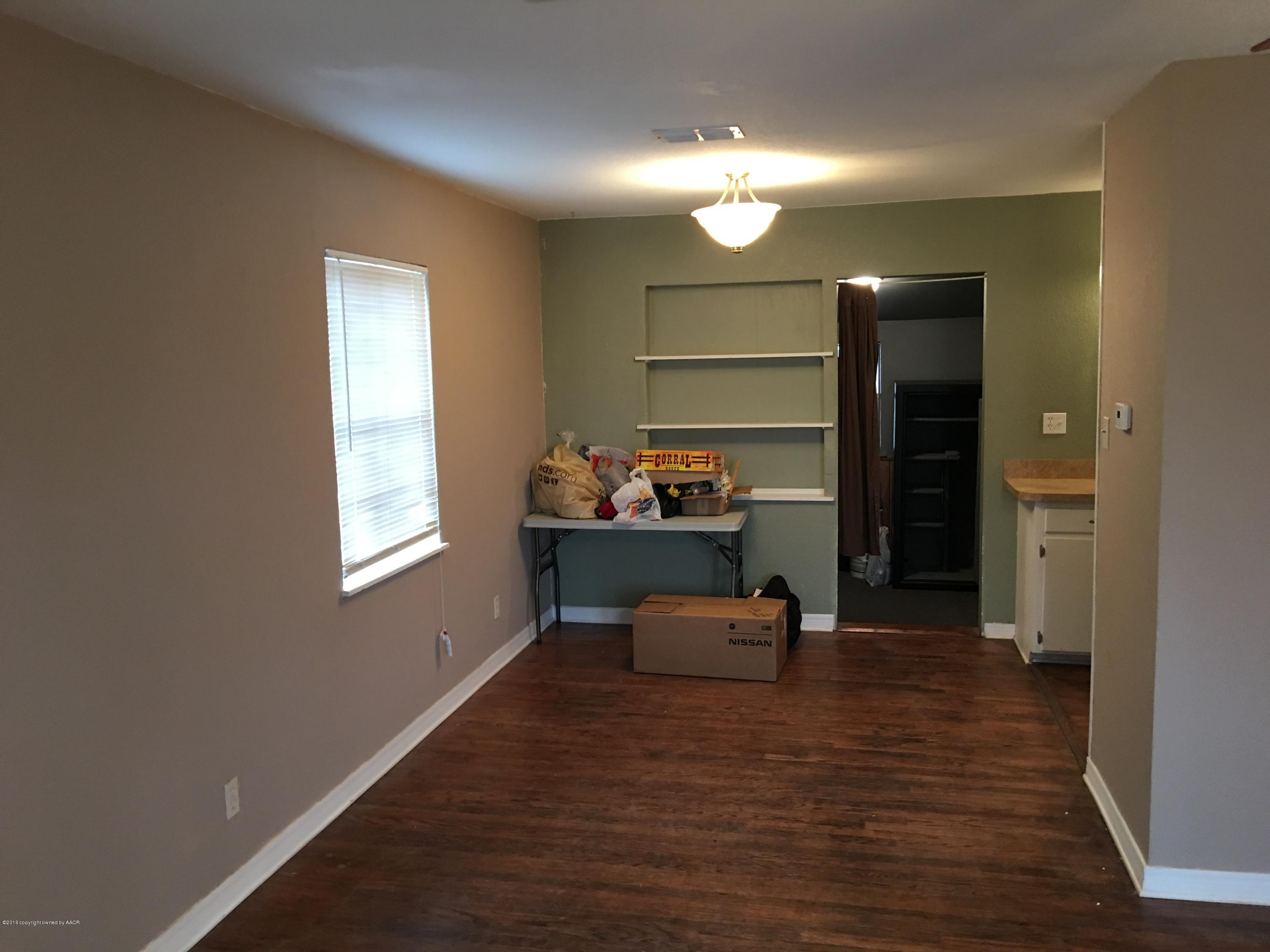 4321 South Travis Street Amarillo, TX 79110 - Photo 16 of 38 a room with wooden floor and window