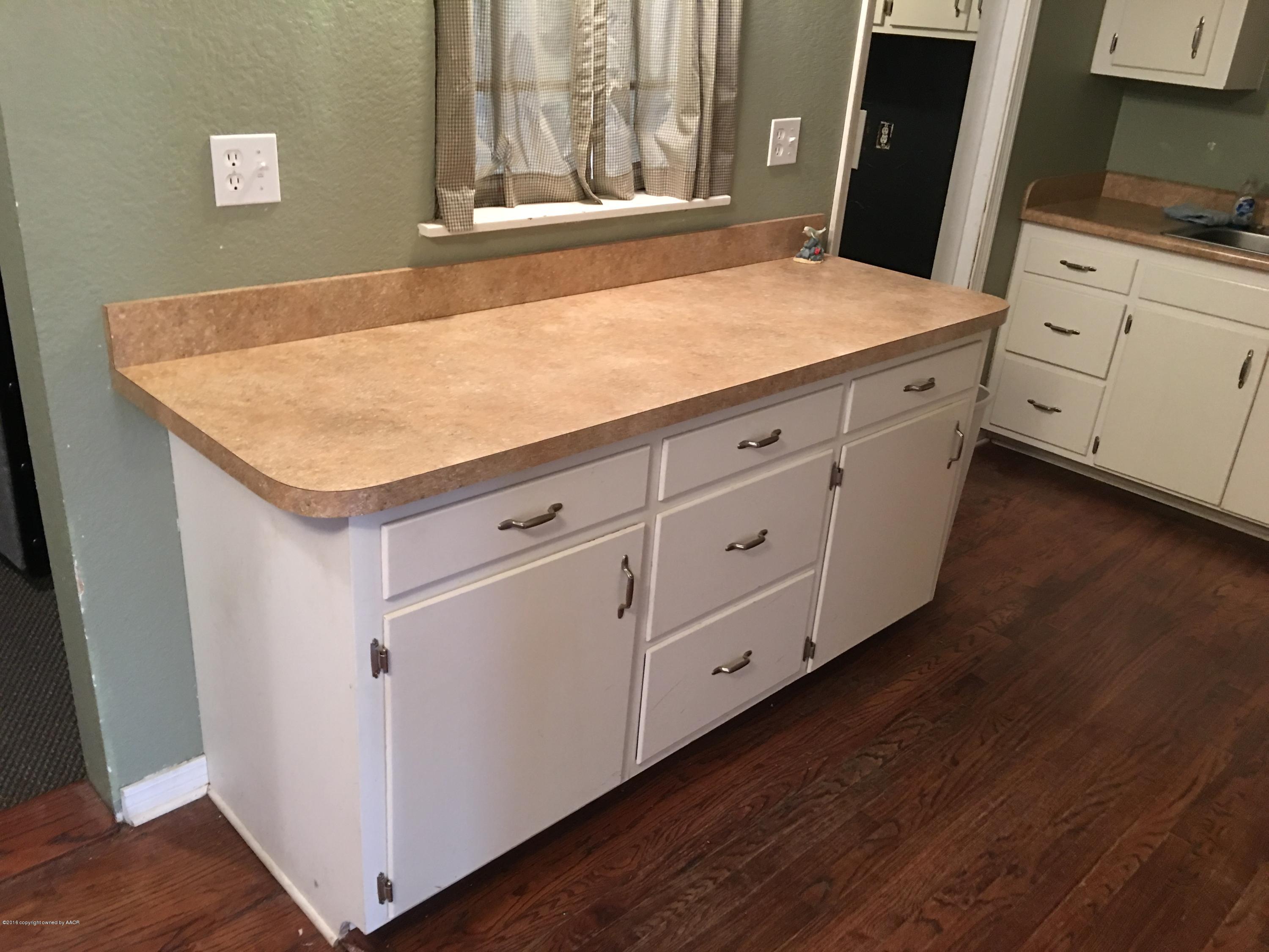 4321 South Travis Street Amarillo, TX 79110 - Photo 19 of 38 a room with white cabinets and wooden floor
