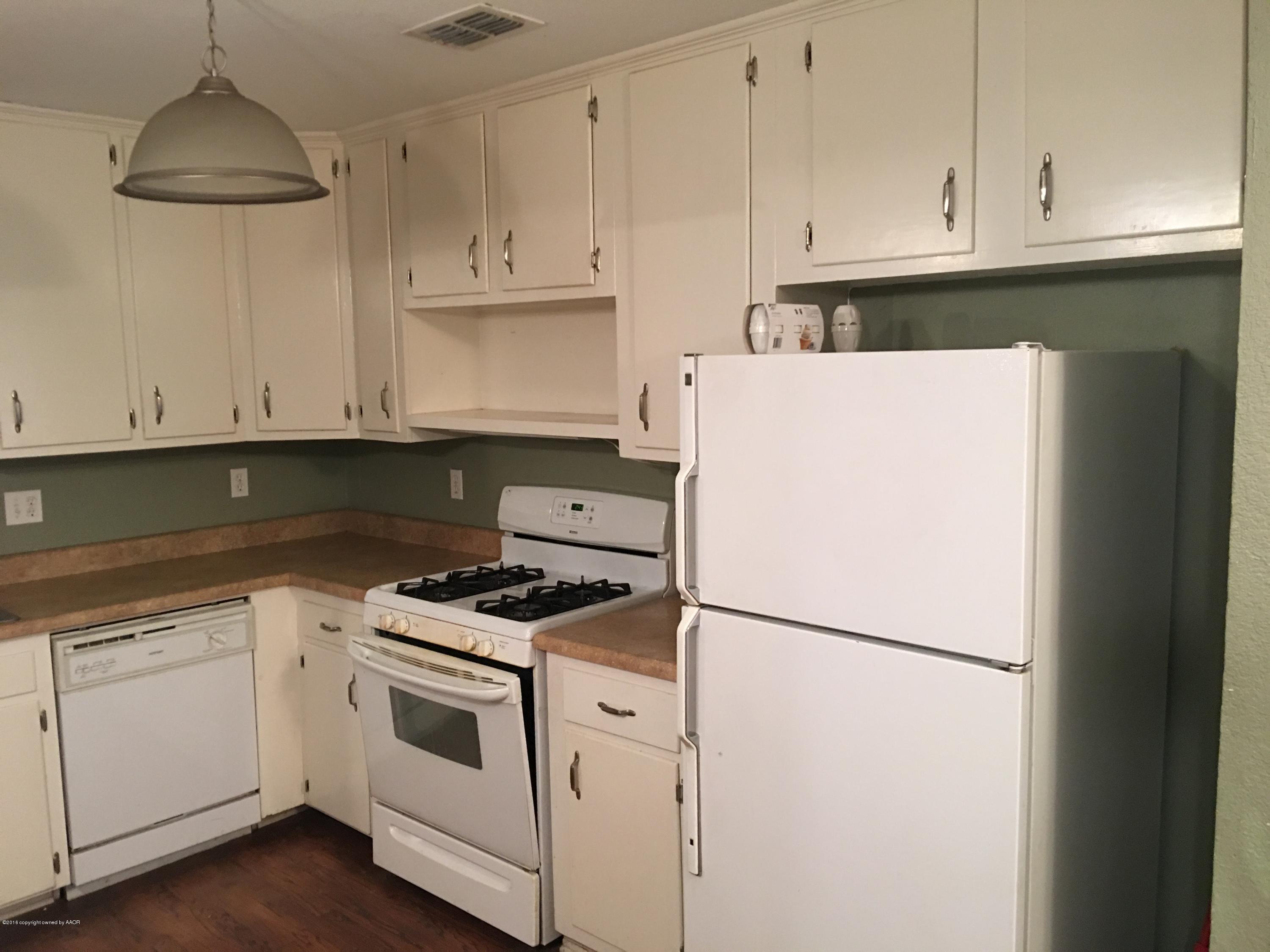 4321 South Travis Street Amarillo, TX 79110 - Photo 20 of 38 a white refrigerator freezer sitting inside of a kitchen