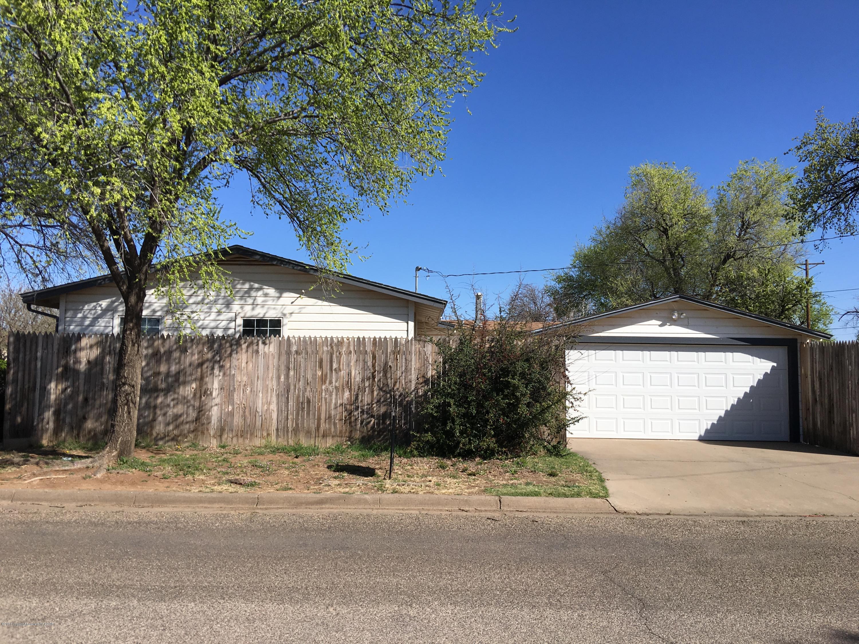 4321 South Travis Street Amarillo, TX 79110 - Photo 2 of 38 a view of a house with a yard and garage