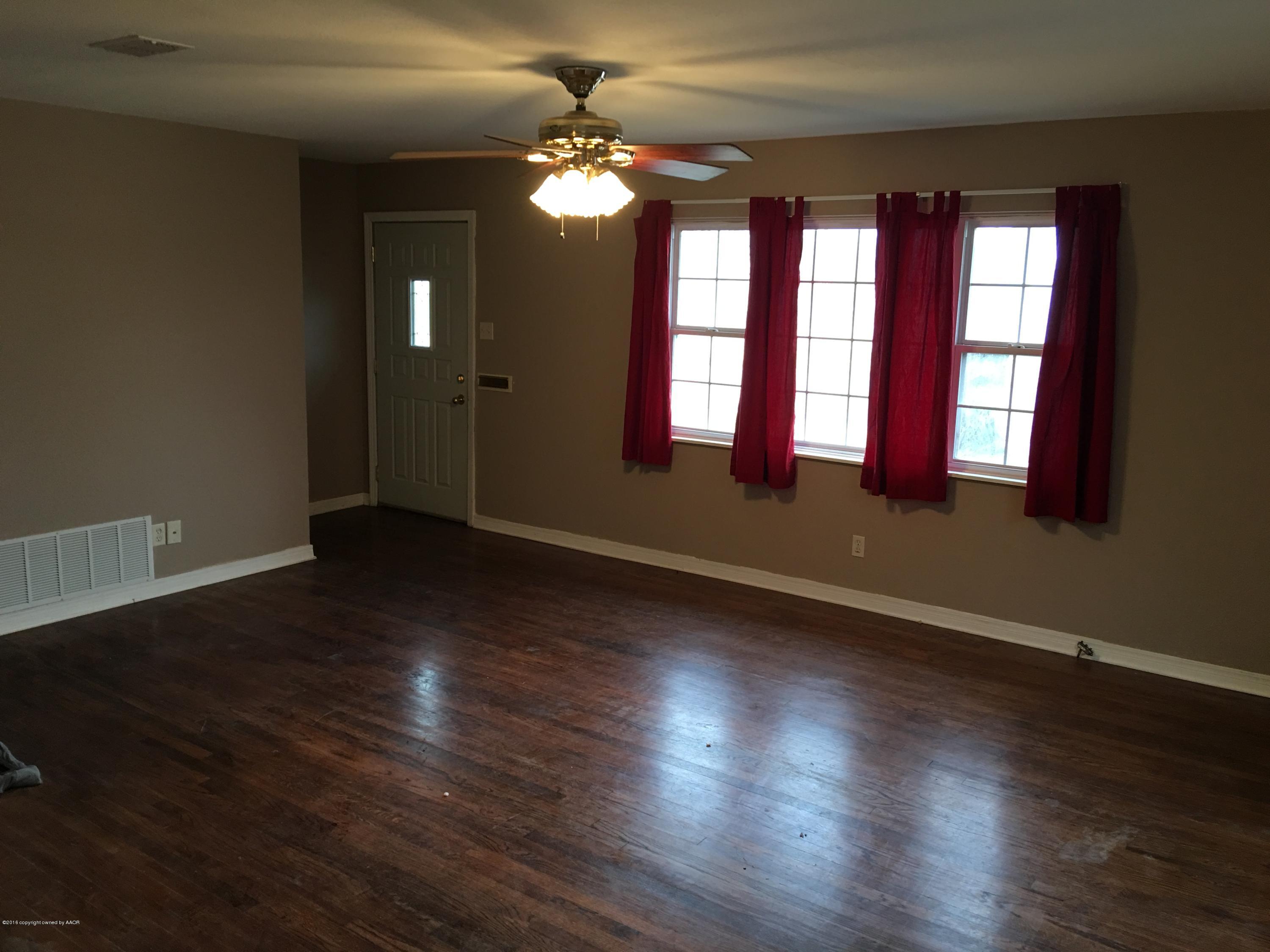 4321 South Travis Street Amarillo, TX 79110 - Photo 3 of 38 an empty room with wooden floor and windows