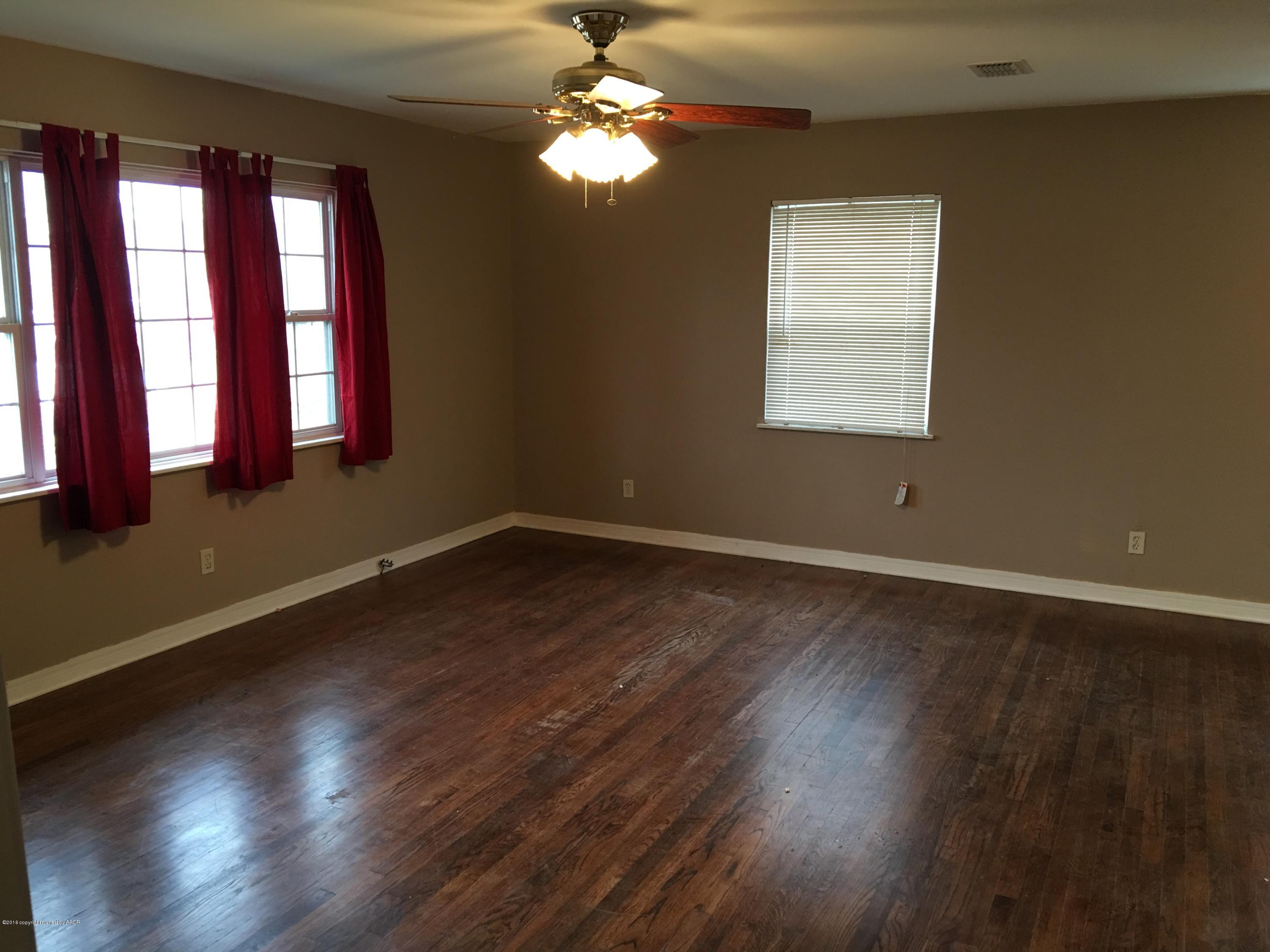 4321 South Travis Street Amarillo, TX 79110 - Photo 4 of 38 a view of wooden floor and windows in a room