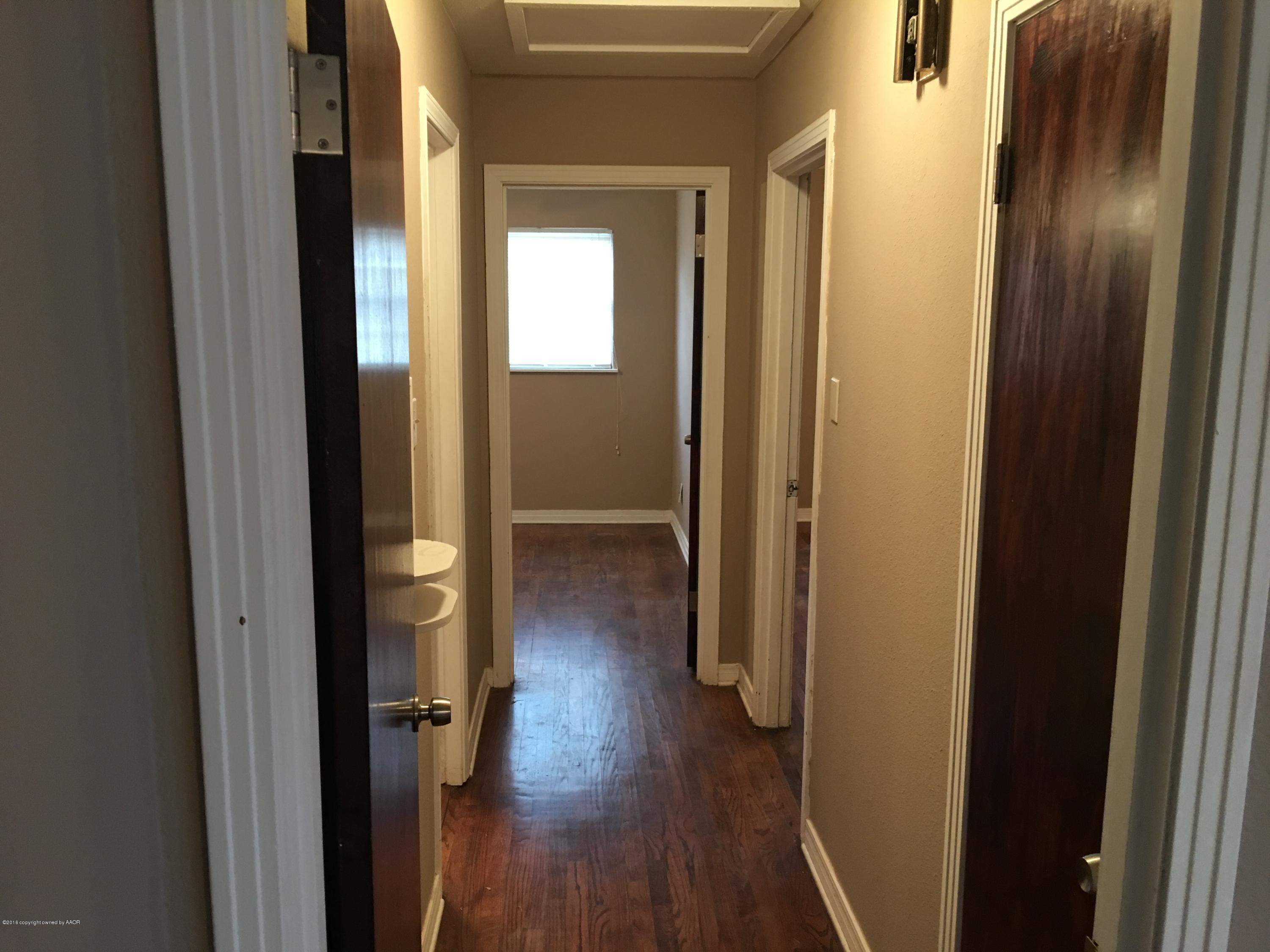 4321 South Travis Street Amarillo, TX 79110 - Photo 5 of 38 a view of a hallway with wooden floor