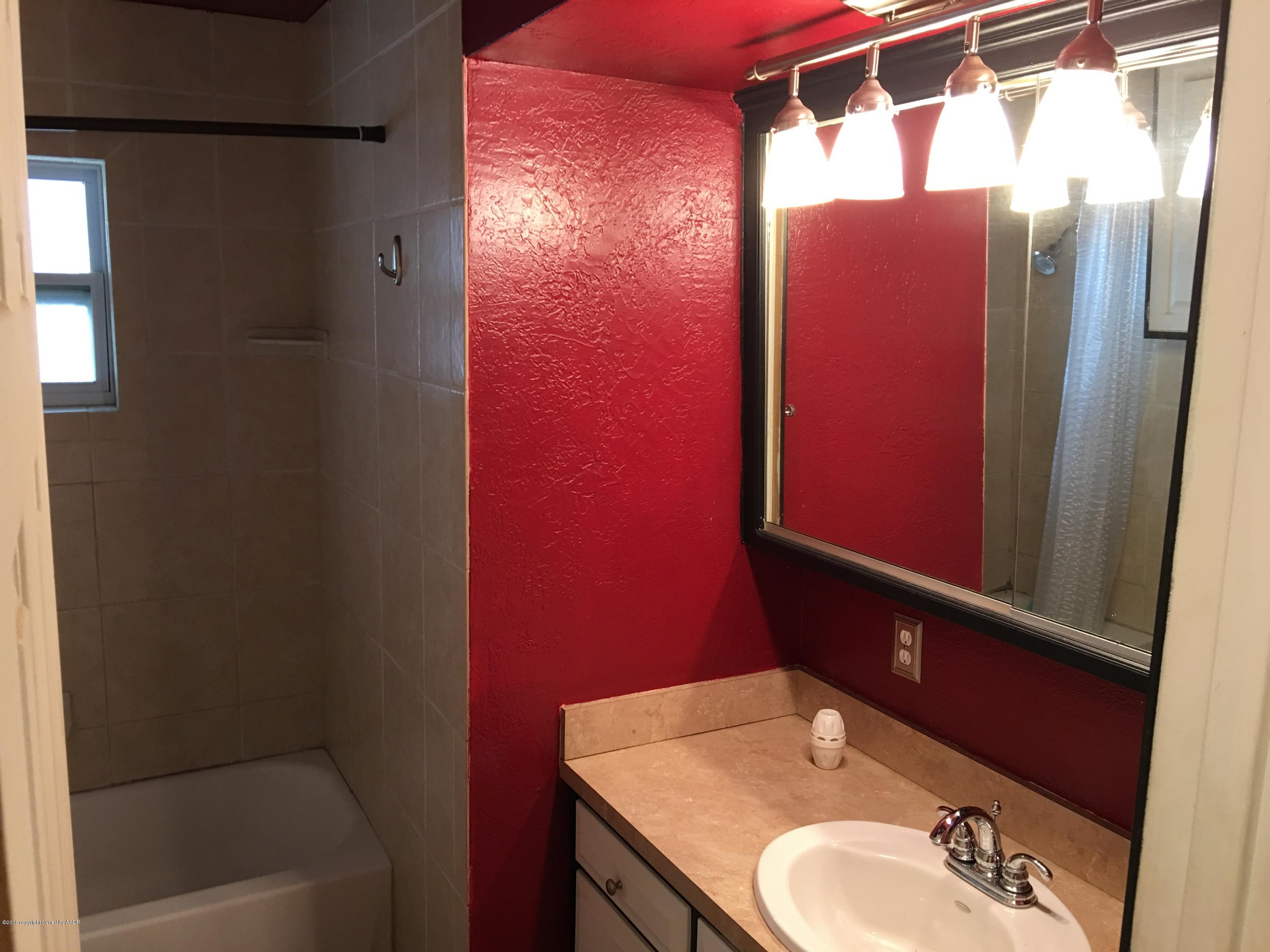 4321 South Travis Street Amarillo, TX 79110 - Photo 6 of 38 a bathroom with a sink and a mirror