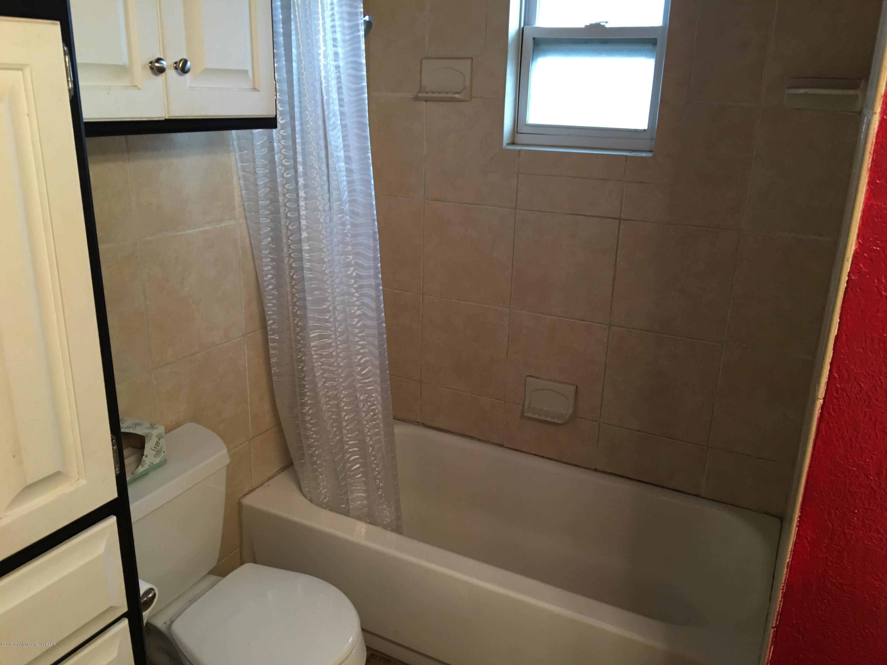 4321 South Travis Street Amarillo, TX 79110 - Photo 7 of 38 a bathroom with a toilet and a shower