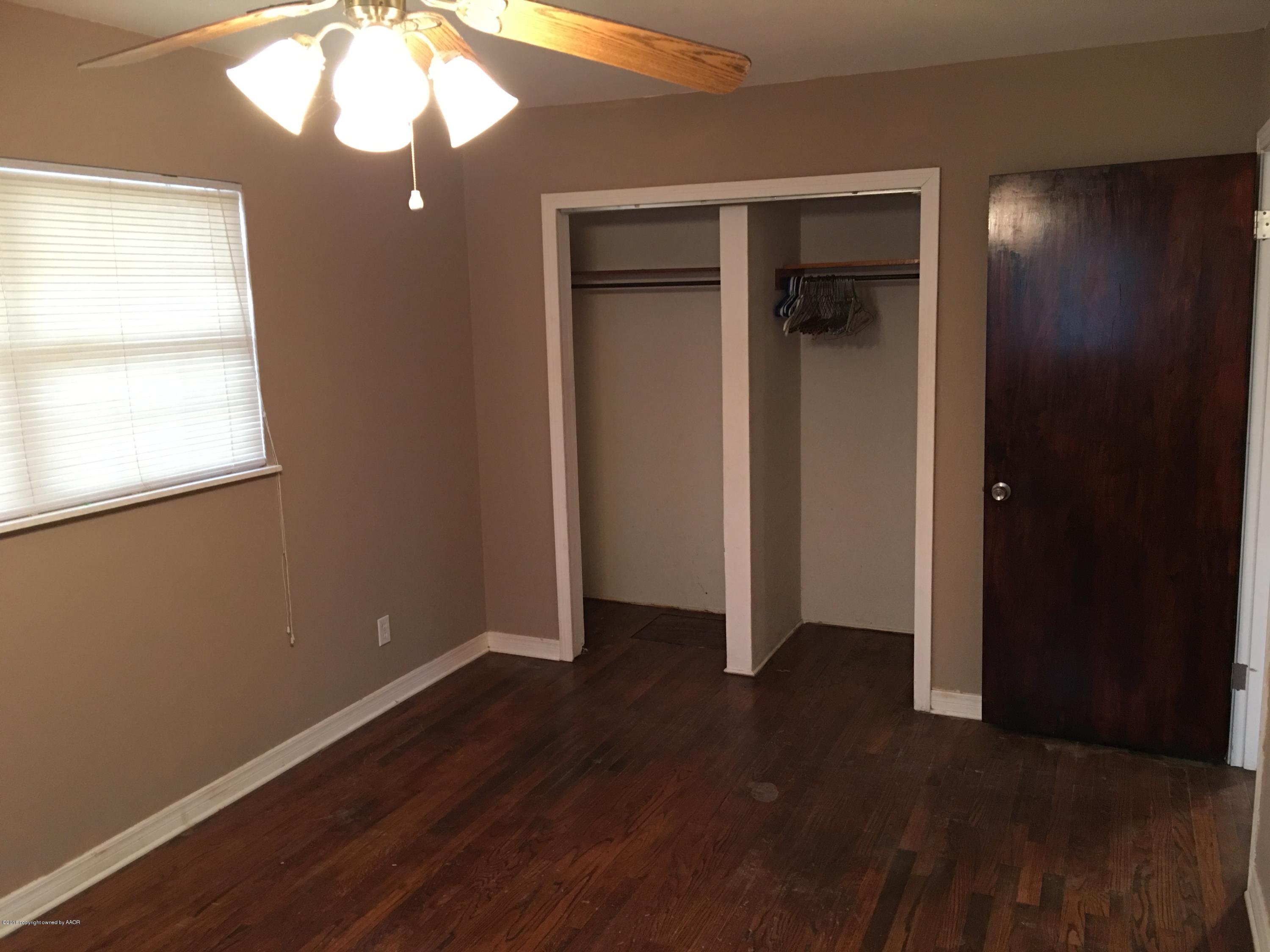 4321 South Travis Street Amarillo, TX 79110 - Photo 10 of 38 an empty room with wooden floor and closet area