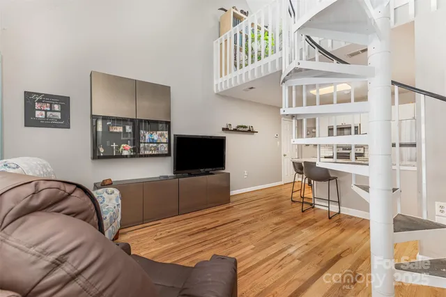 a kitchen with granite countertop cabinets stainless steel appliances and wooden floor