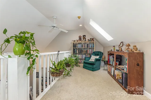 a bed room with a bed and a ceiling fan