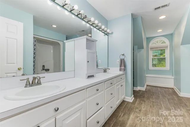 a bathroom with a shower and a sink