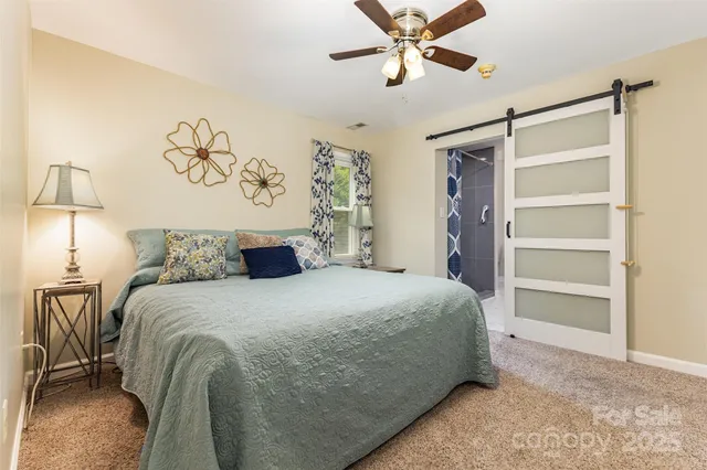 a bathroom with a granite countertop sink a toilet and shower