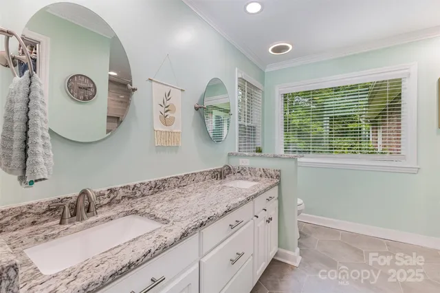 a living room with furniture and a ceiling fan
