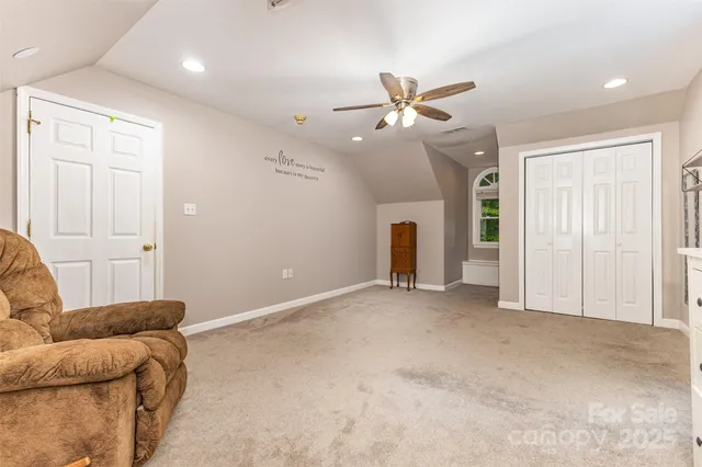 an empty room with furniture and flat screen tv