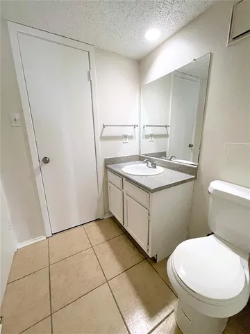 a bathroom with a sink a toilet a mirror and a shower