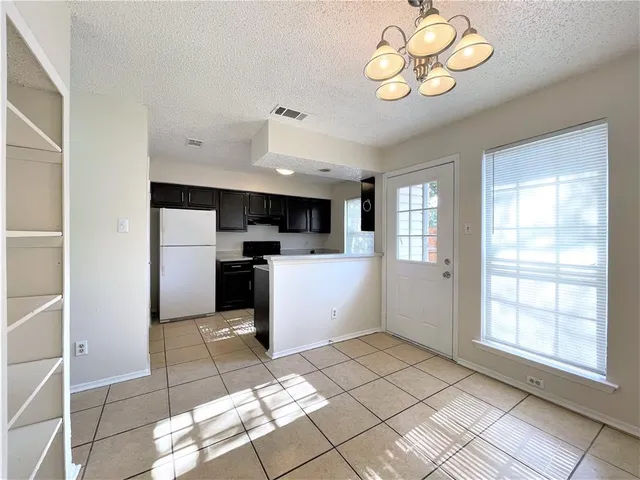a kitchen with a refrigerator a sink and cabinets