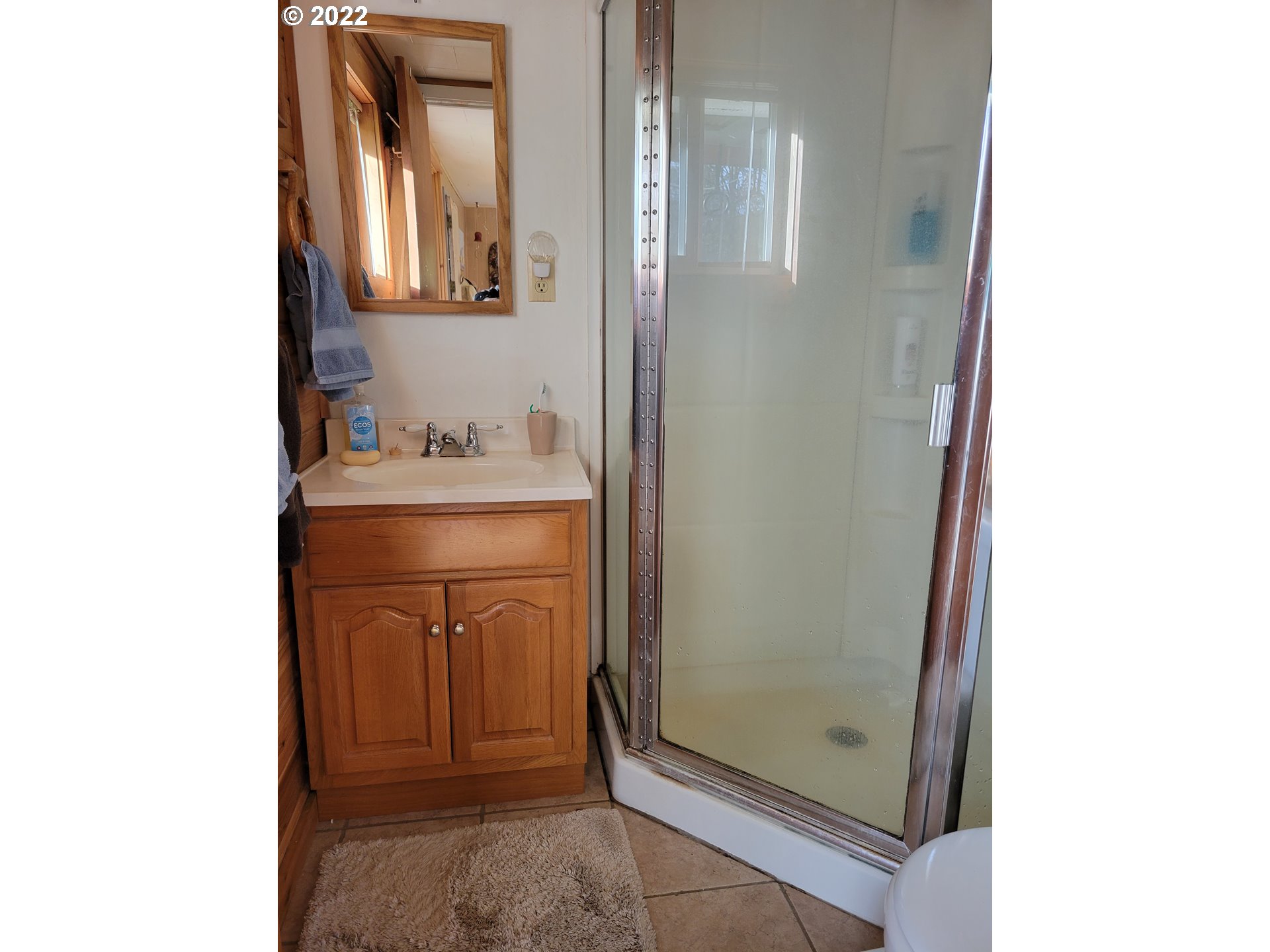 5064 Henderer Road Elkton, OR 97436 - Photo 11 of 32 a bathroom with a sink a mirror and vanity