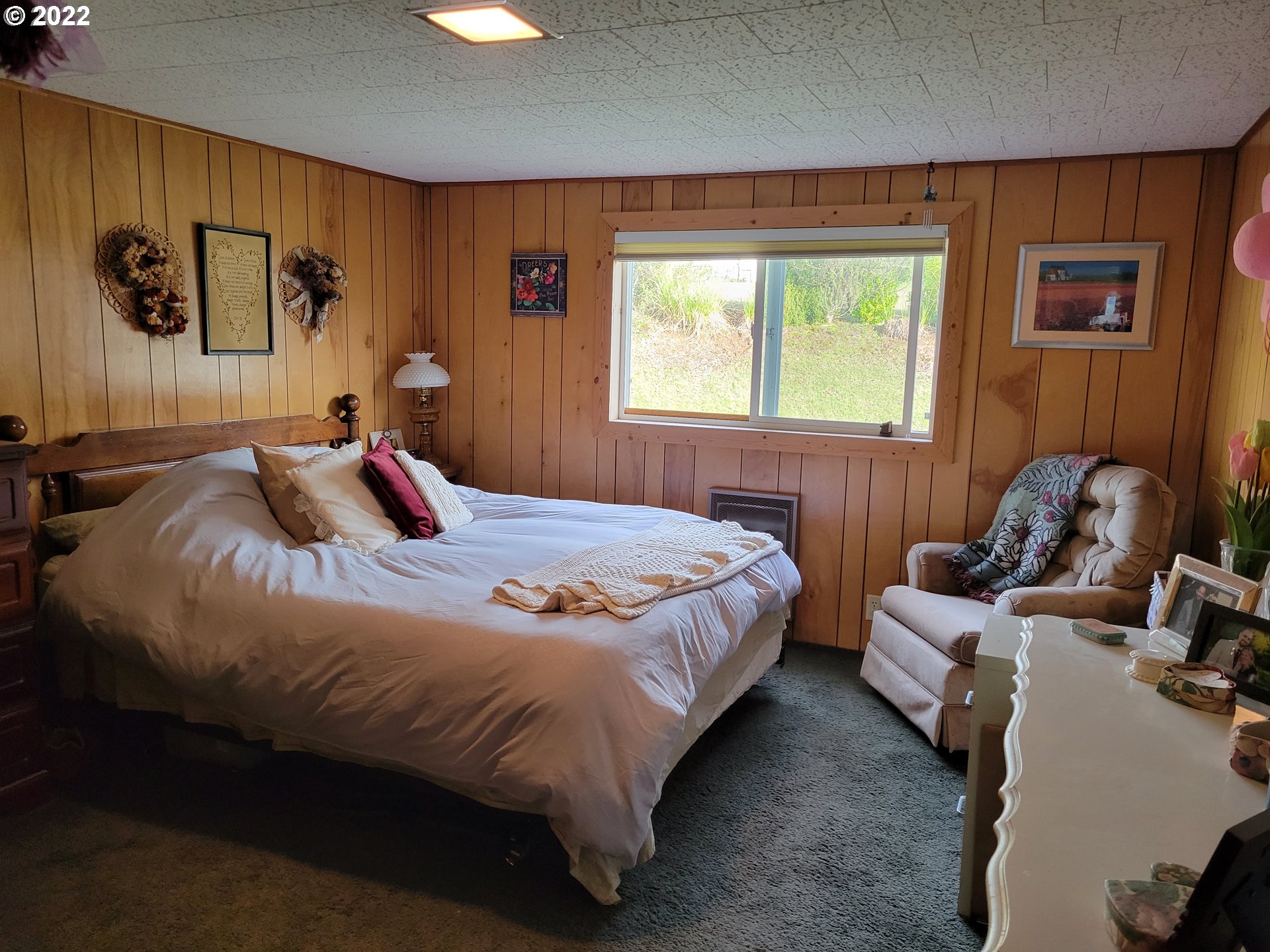 5064 Henderer Road Elkton, OR 97436 - Photo 8 of 32 a bedroom with a bed and wooden floor