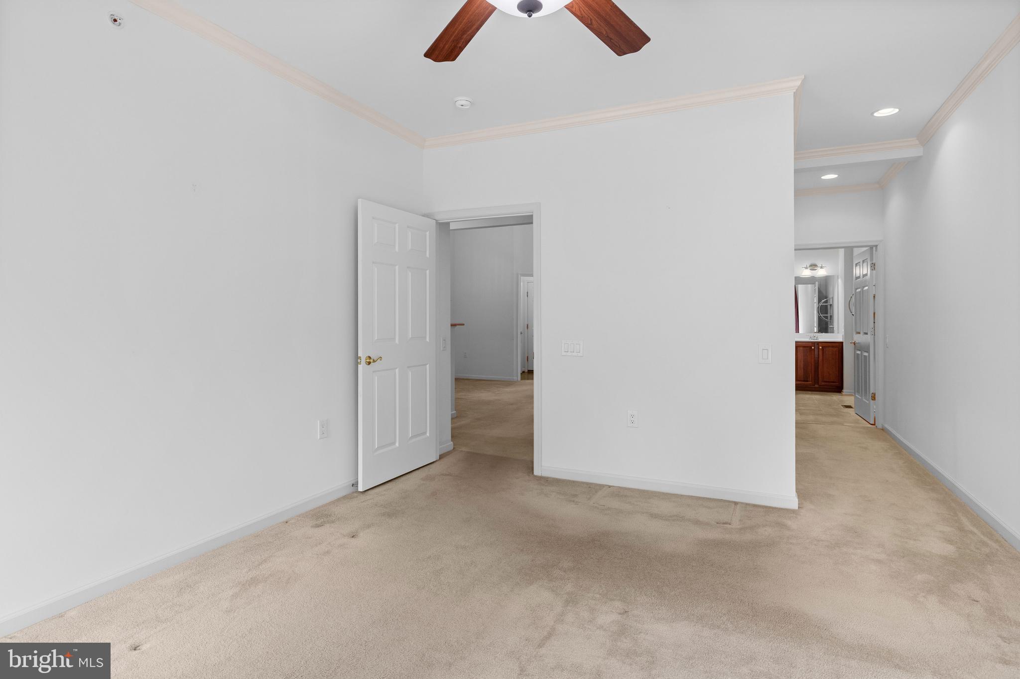 815 Geranium Drive Warrington, PA 18976 - Photo 14 of 33 an empty room with chandelier fan and kitchen view
