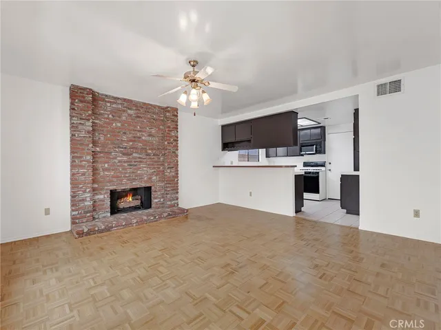 a view of a kitchen with a sink a kitchen microwave and refrigerator