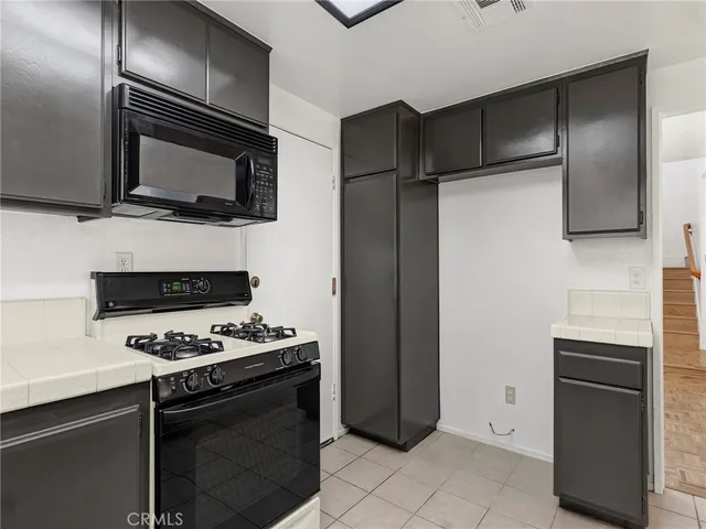 a kitchen with a refrigerator stove and microwave