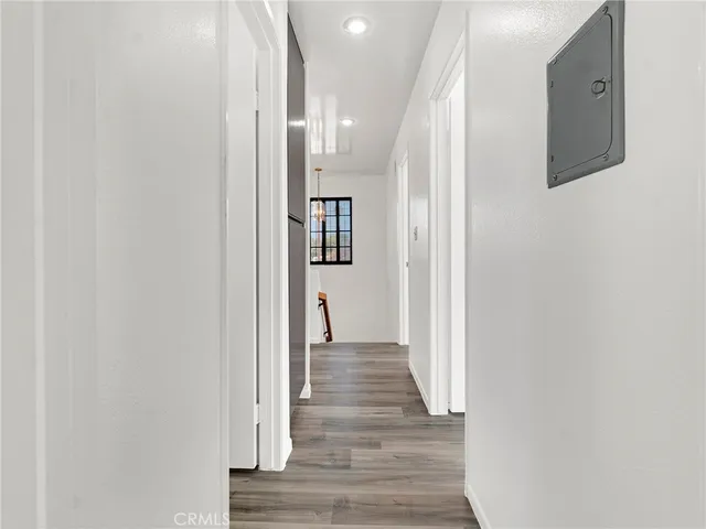 a view of a hallway with wooden floor