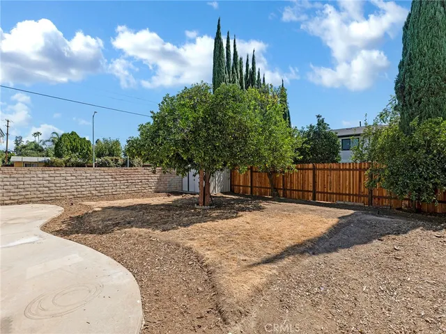 a view of a backyard with large trees