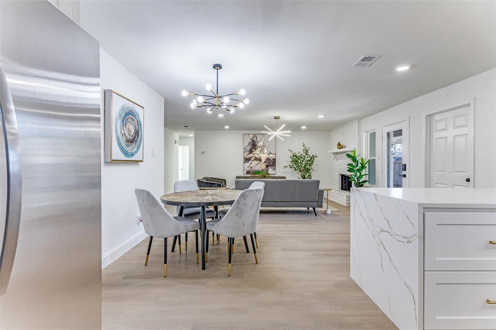 7609 Walnuthill Court Watauga, TX 76148 - Photo 12 of 22 a view of a dining room with furniture and chandelier