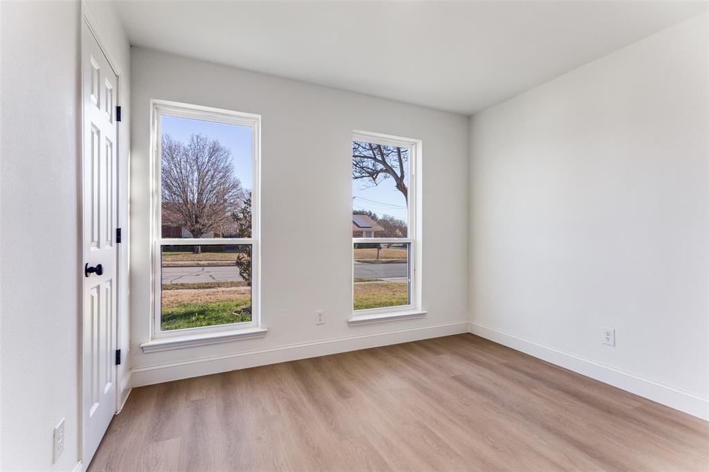 7609 Walnuthill Court Watauga, TX 76148 - Photo 14 of 22 an empty room with wooden floor and window