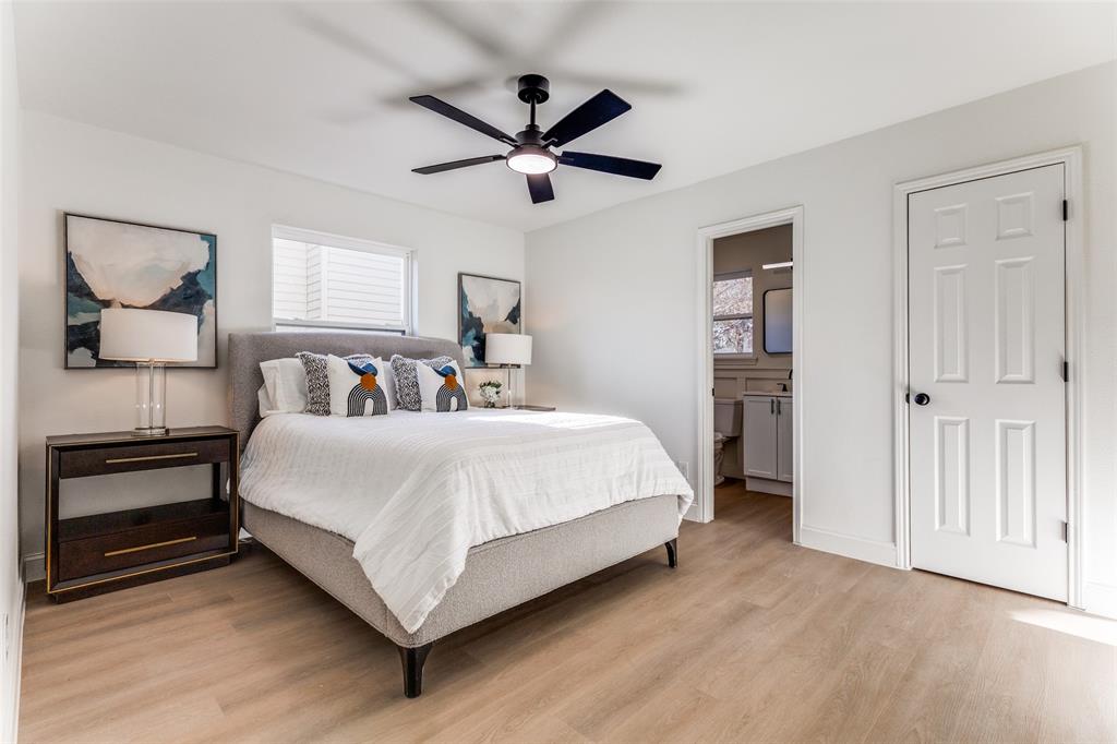 7609 Walnuthill Court Watauga, TX 76148 - Photo 17 of 22 a bed room with a bed and a ceiling fan