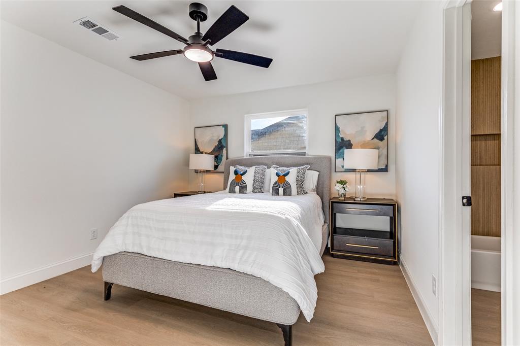 7609 Walnuthill Court Watauga, TX 76148 - Photo 18 of 22 a bedroom with a bed and a ceiling fan