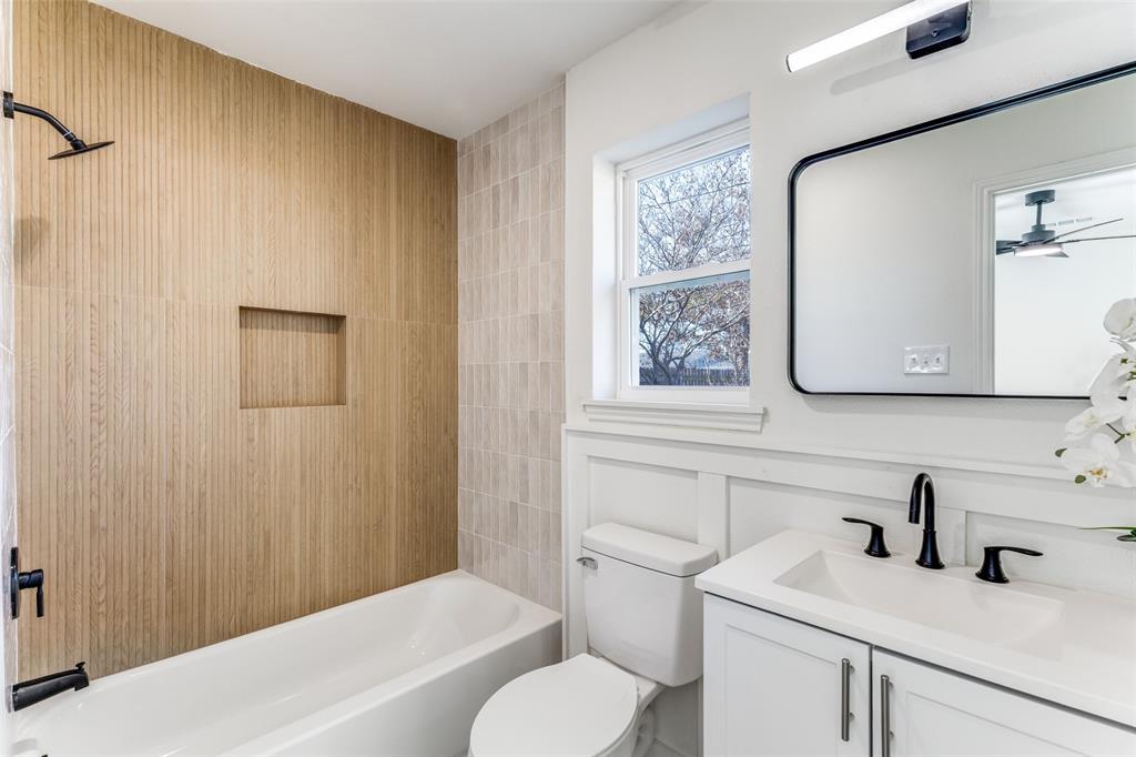 7609 Walnuthill Court Watauga, TX 76148 - Photo 20 of 22 a bathroom with a sink toilet and vanity