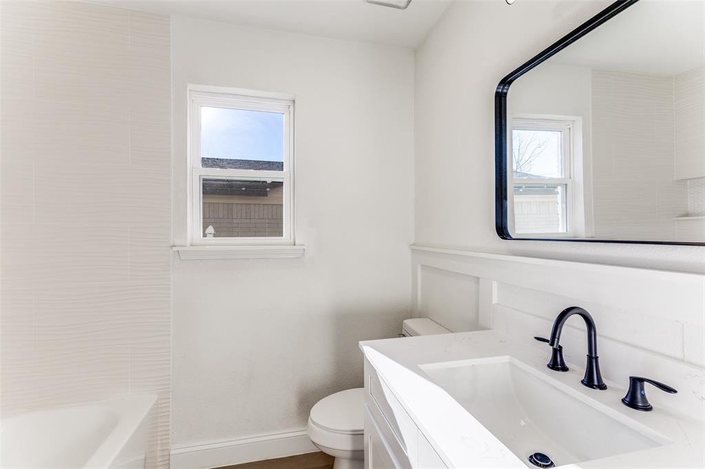 7609 Walnuthill Court Watauga, TX 76148 - Photo 21 of 22 a bathroom with a sink toilet and mirror