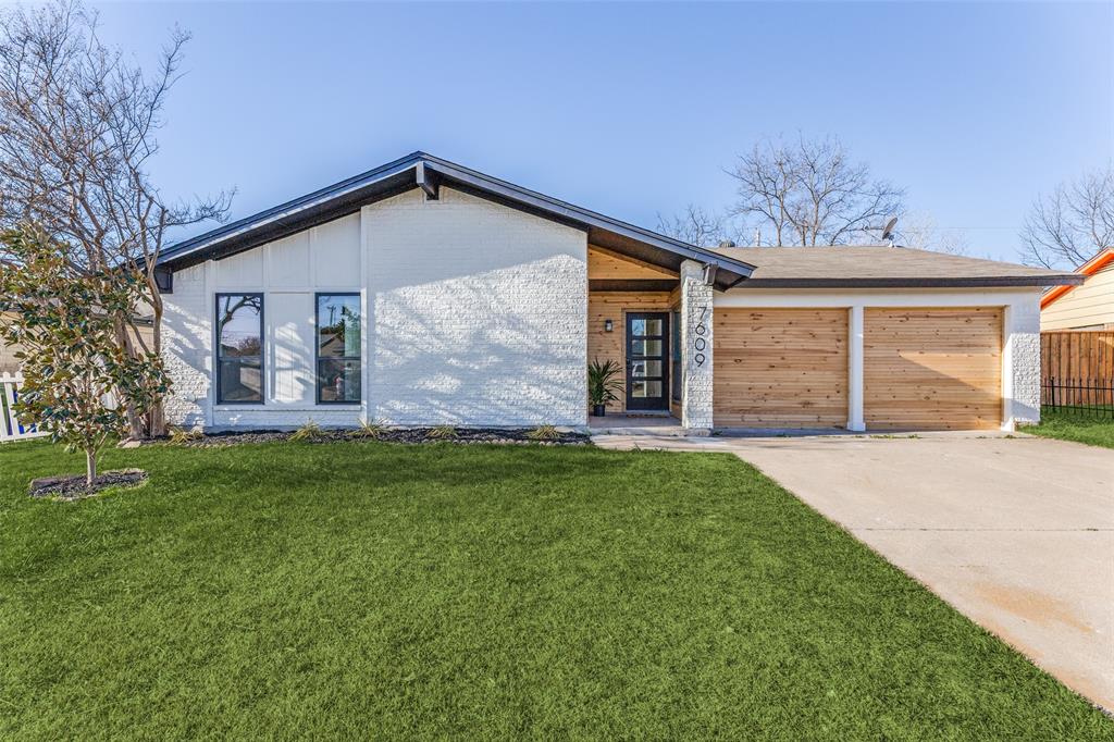 7609 Walnuthill Court Watauga, TX 76148 - Photo 3 of 22 a front view of a house with a garden