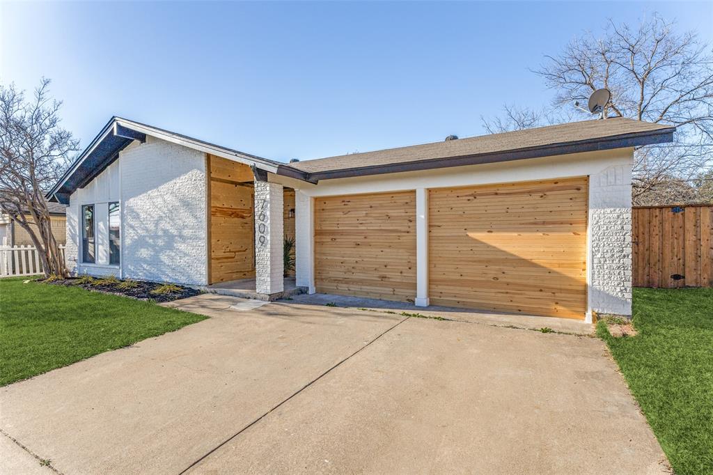 7609 Walnuthill Court Watauga, TX 76148 - Photo 4 of 22 a front view of a house with a yard and garage