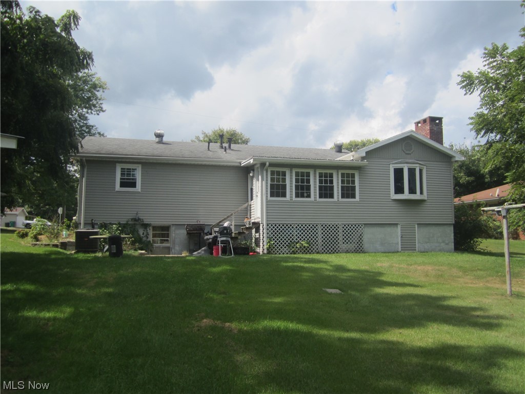 200 Summit Road Marietta, OH 45750 - Photo 11 of 35 Rear view of property featuring central air condition unit and a lawn