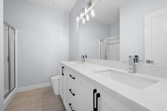 a bathroom with double vanity sink and a mirror