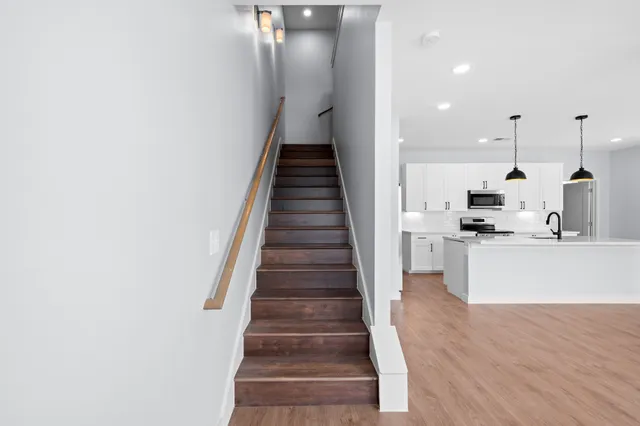a view of kitchen with sink and refrigerator