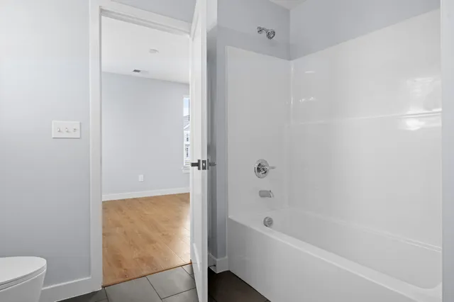 a bathroom with a bathtub and a toilet