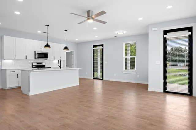 a view of kitchen with cabinets and wooden floor