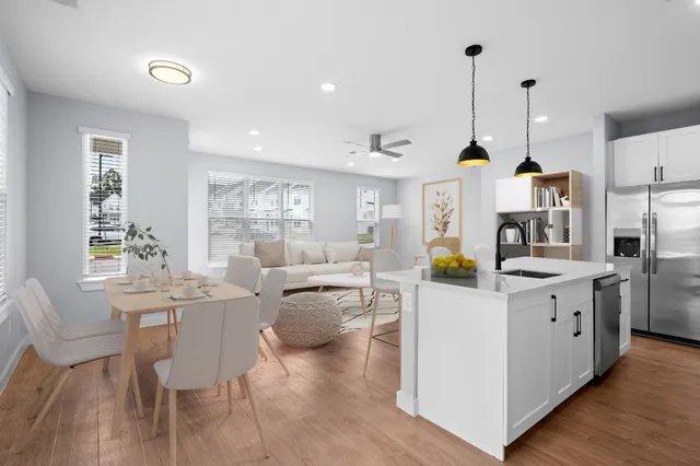 a living room with furniture a dining table and chairs