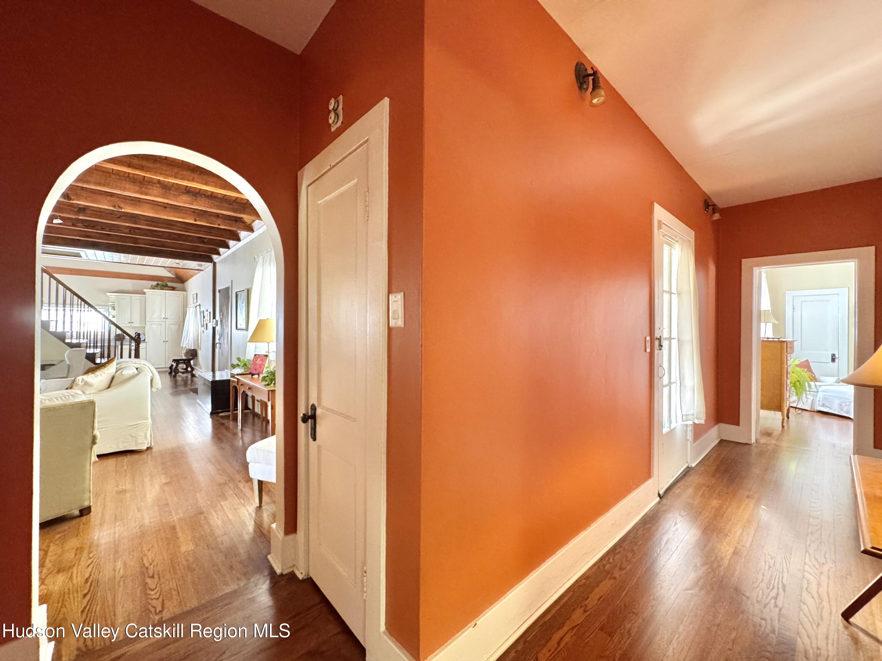 121 High Street Catskill, NY 12414 - Photo 12 of 29 a view of a hallway with wooden floor and a living room