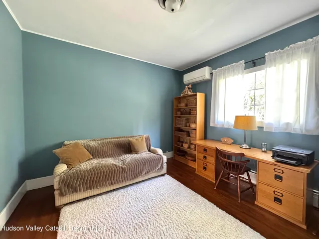 a bedroom with furniture and a window