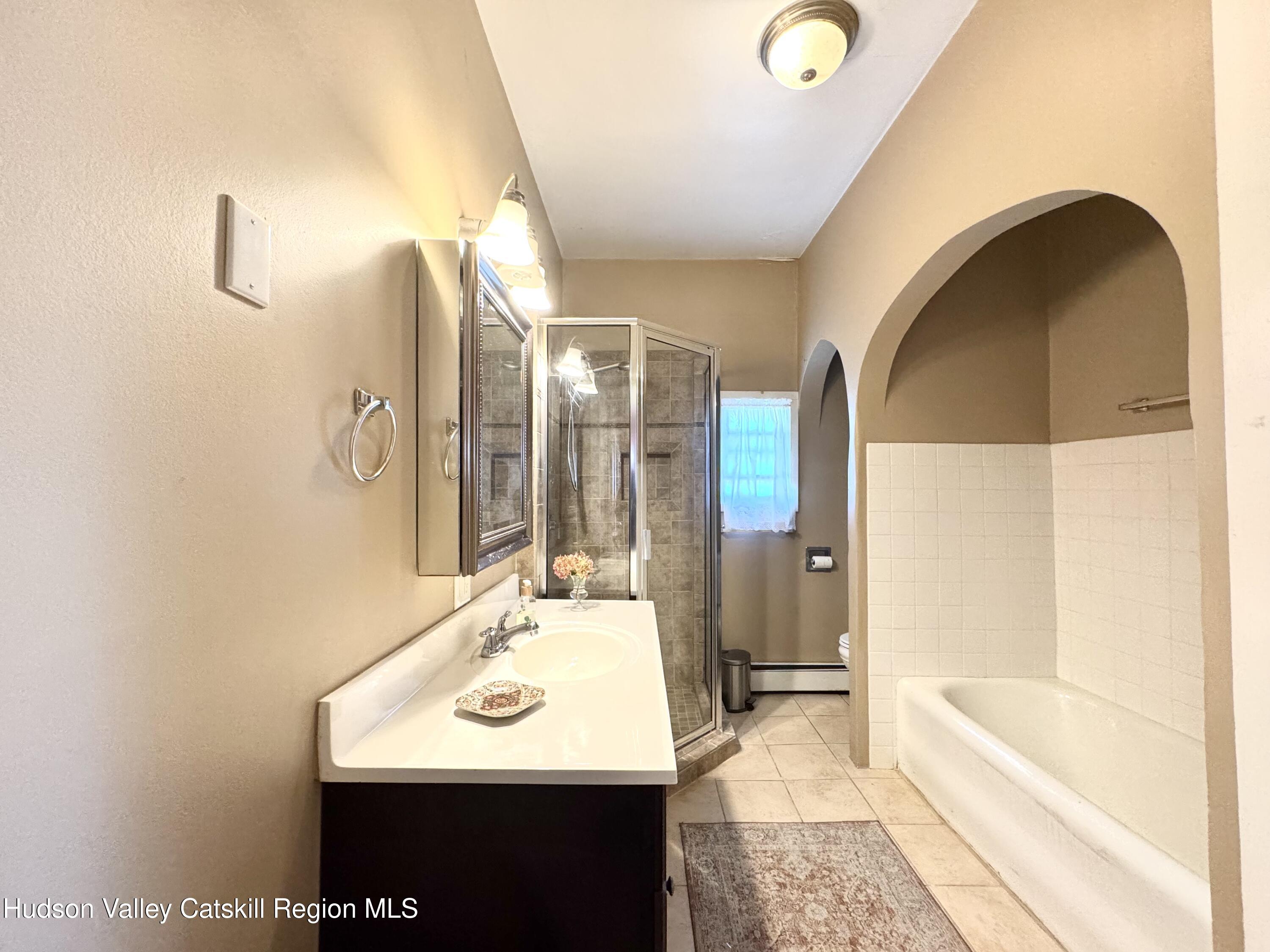 121 High Street Catskill, NY 12414 - Photo 18 of 29 a bathroom with a sink and a mirror